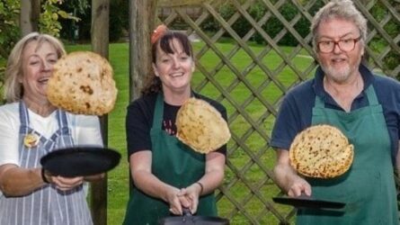 Three people flipping pancakes