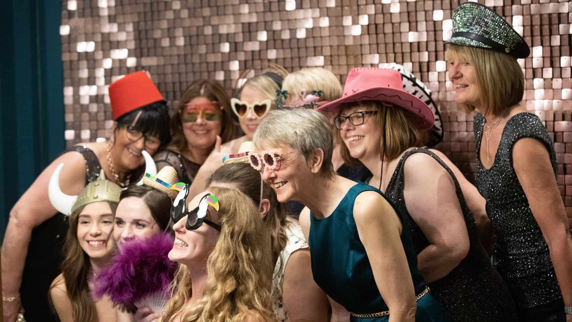 People wearing funny hats, glasses and accessories for photoshoot