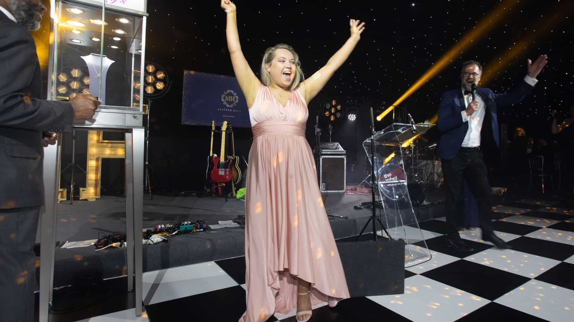 Woman in ball gown cheering