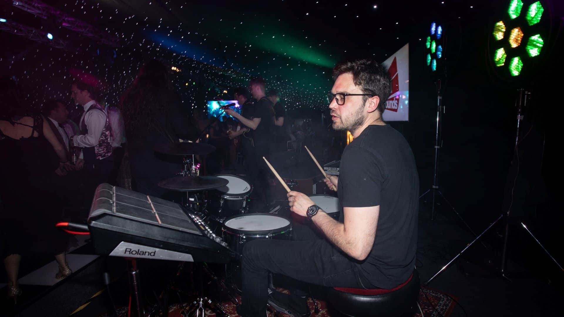 Drummer playing with live band