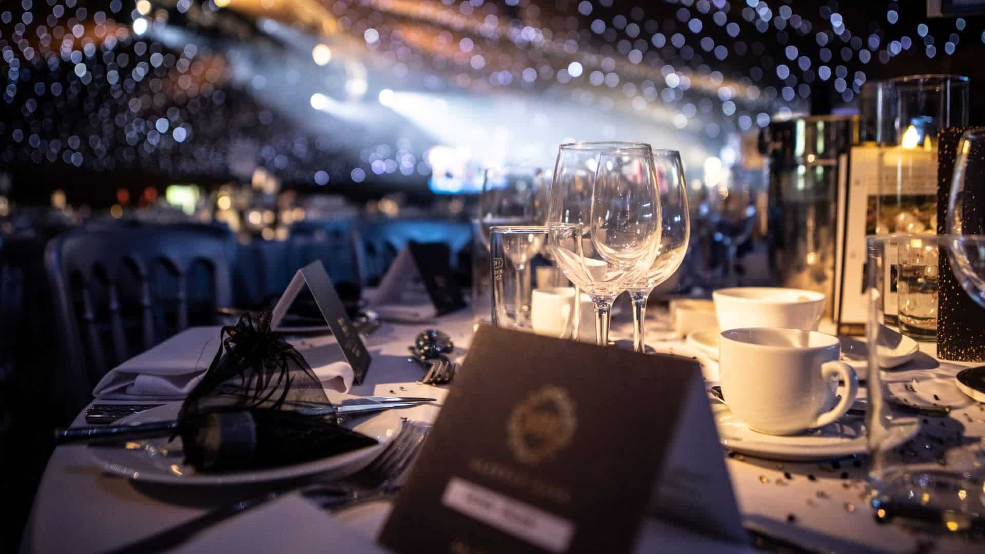 Table with label and close up of wine glasses.