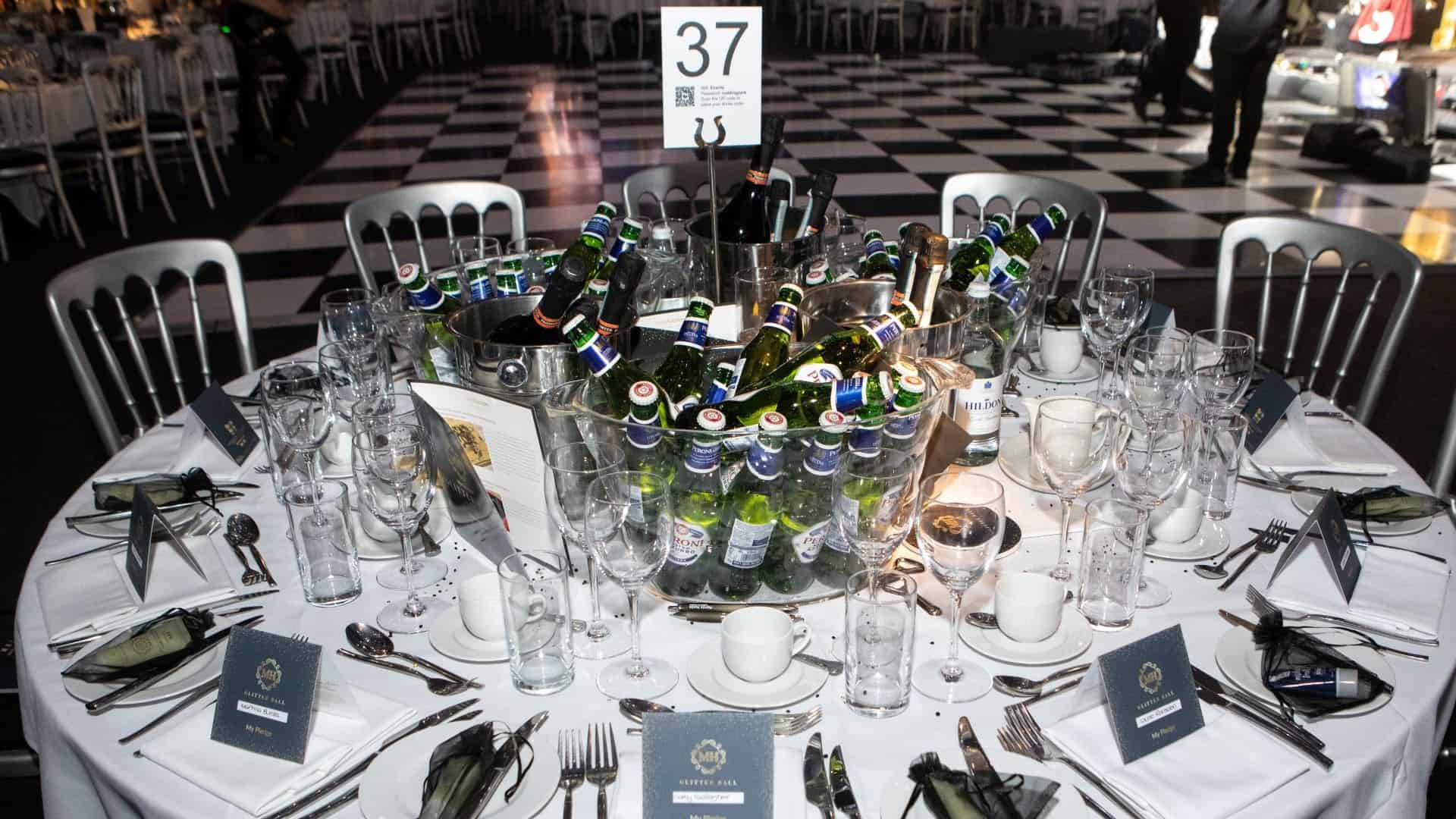 Table set up for ball with drinks in the middle.