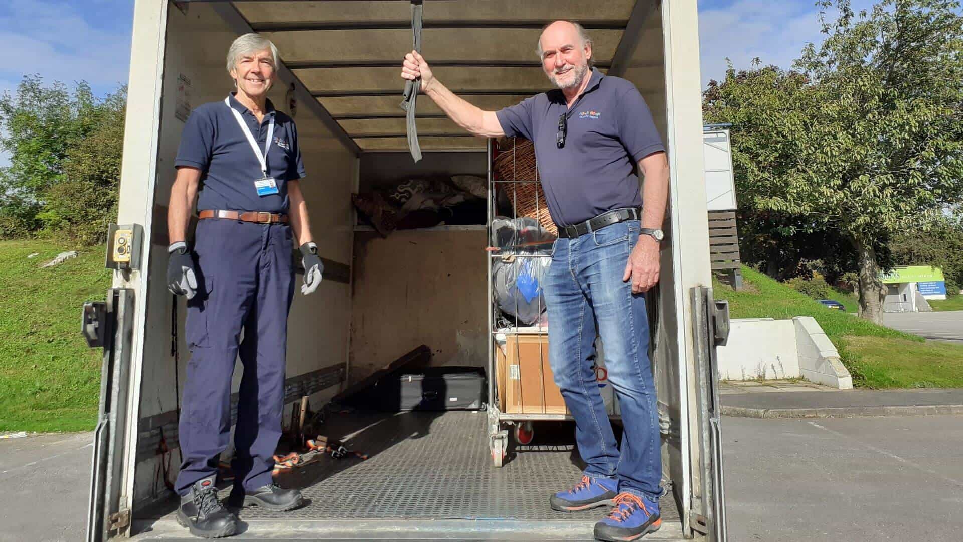 Two men loading a furniture van