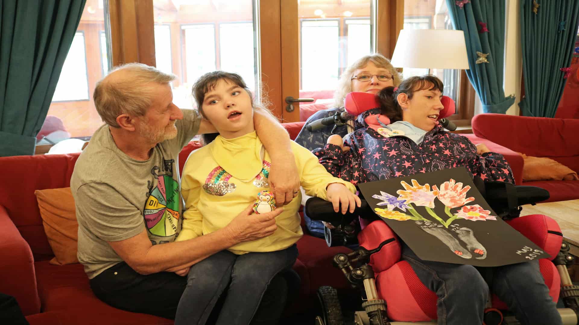 Family sat together on sofa