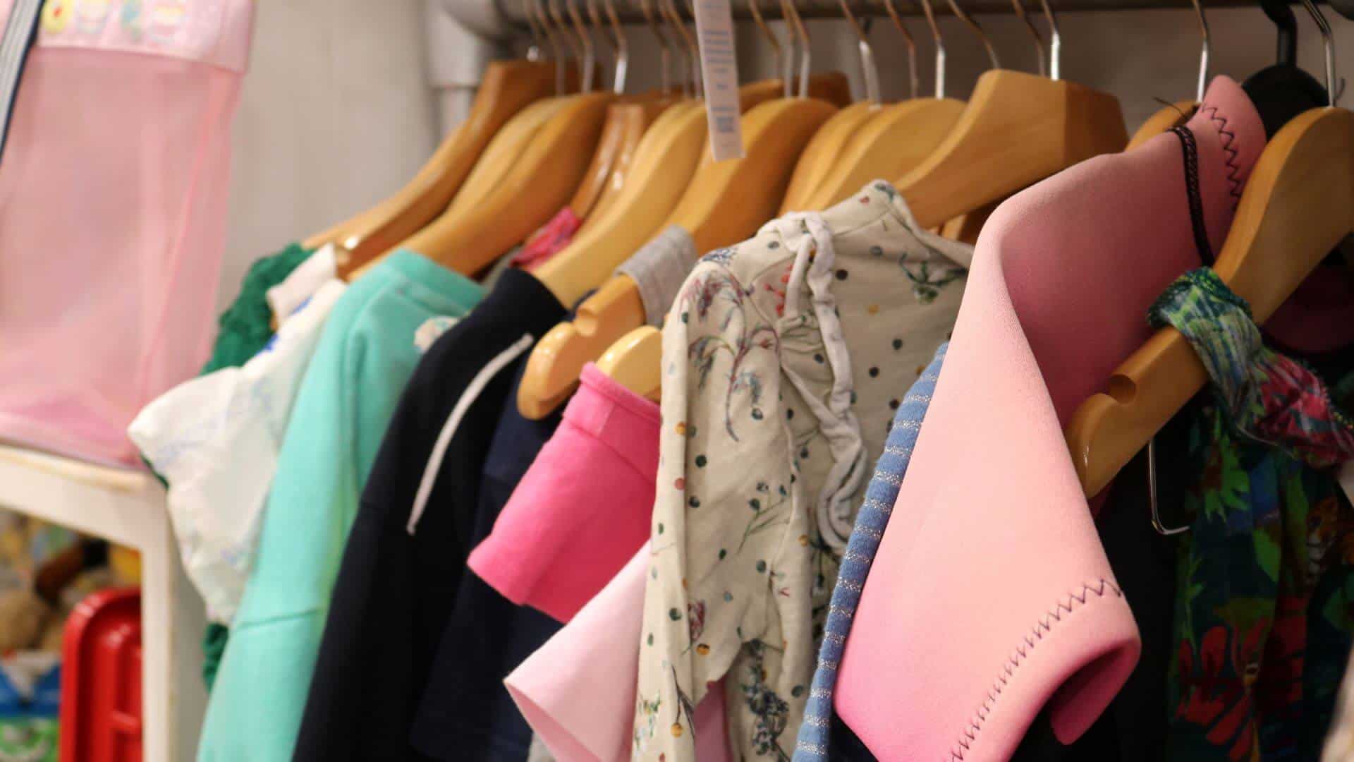 Close up of clothes on hangers.