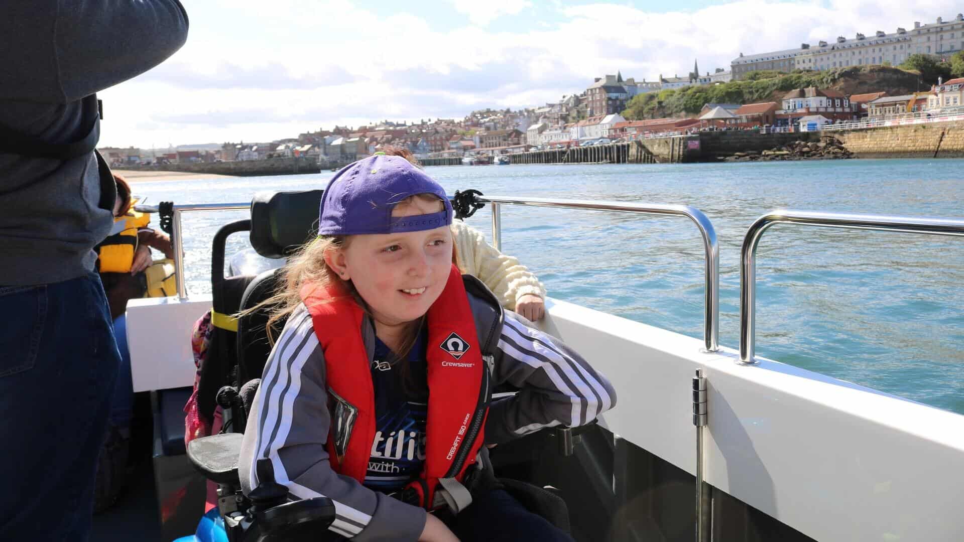 Young girl wearing life jacket on boat.