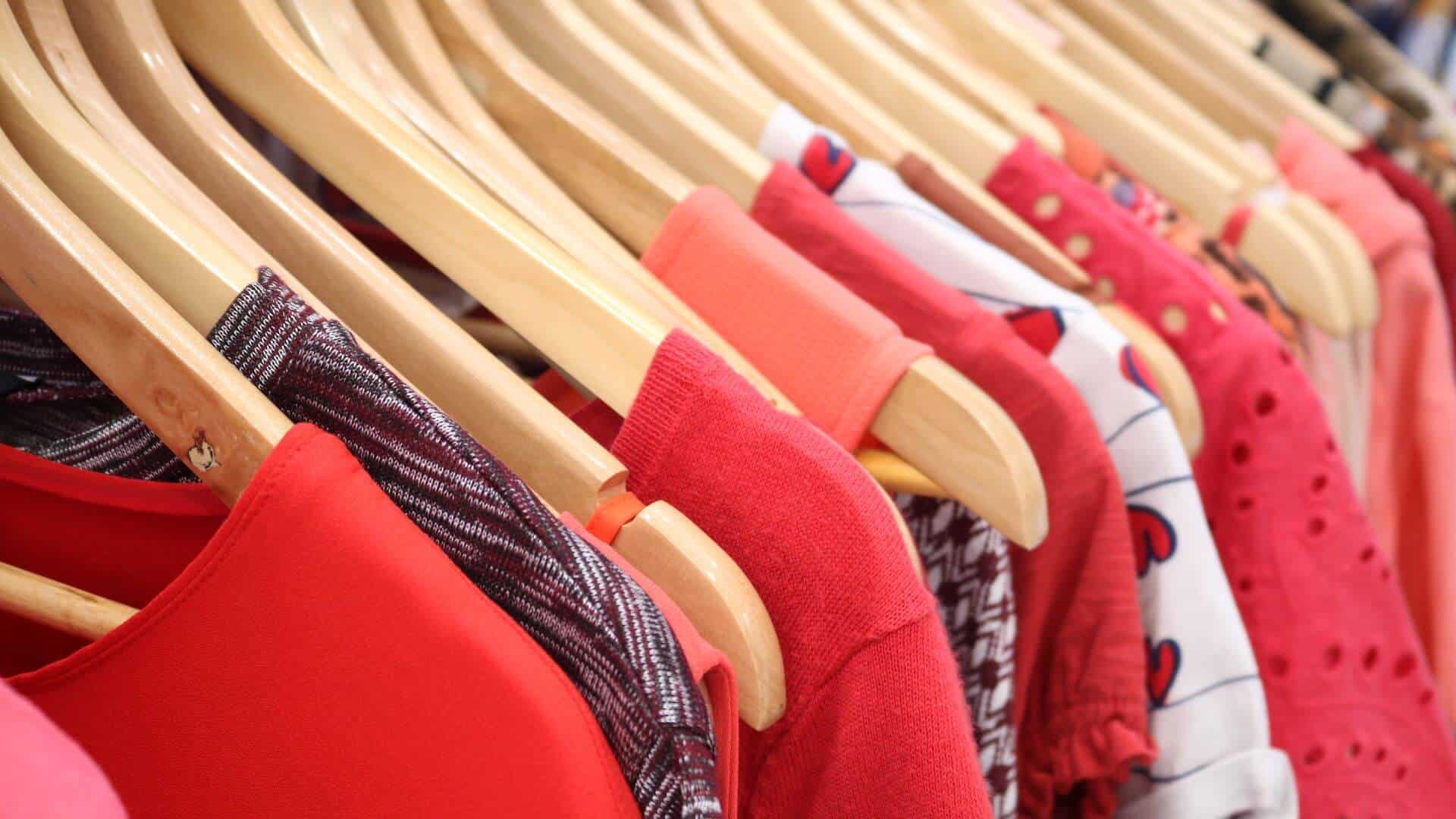 Close of up of red clothes hanging on rack.