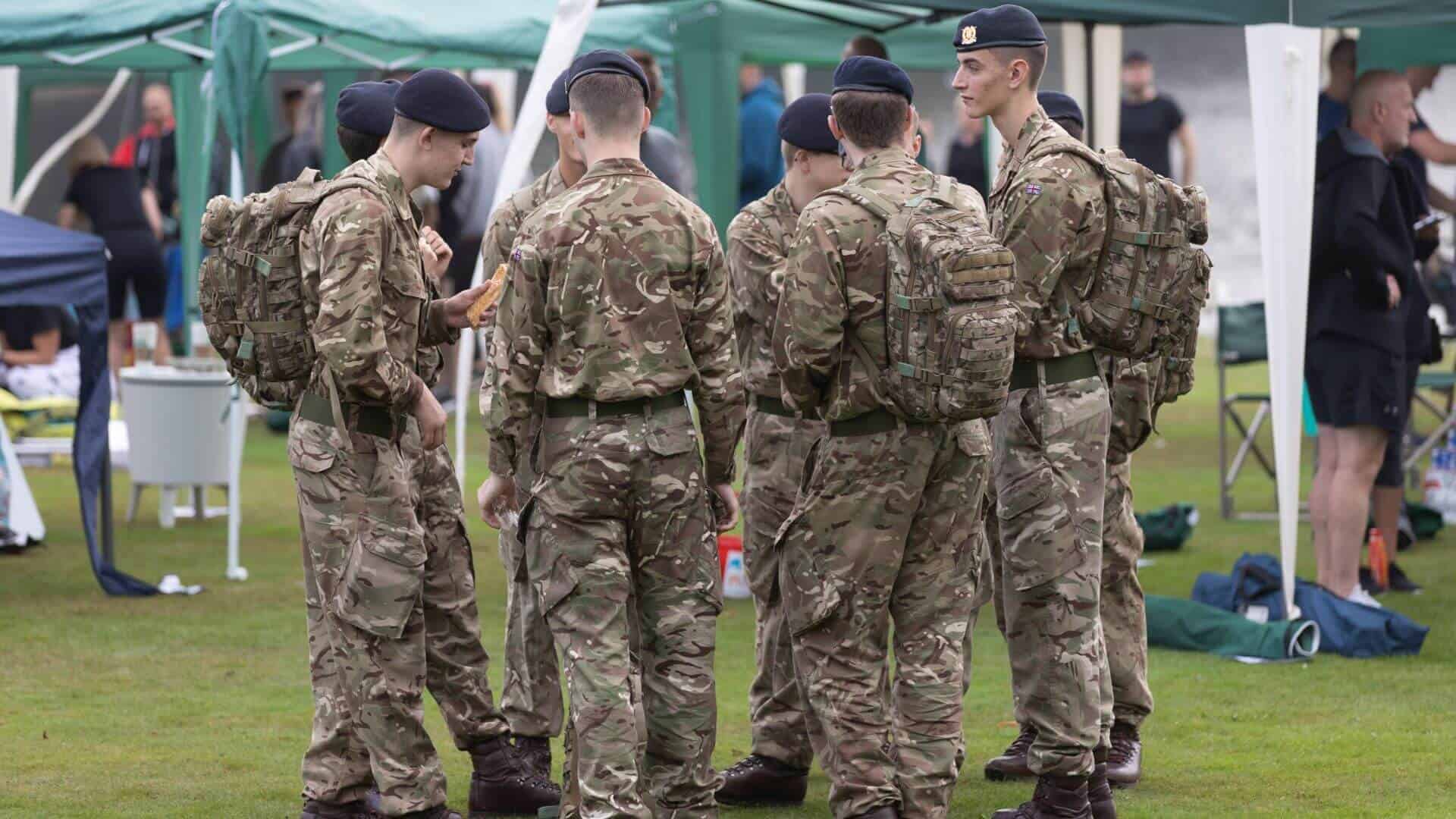 DBR volunteers Five men dressed in camo army uniform stood outside.