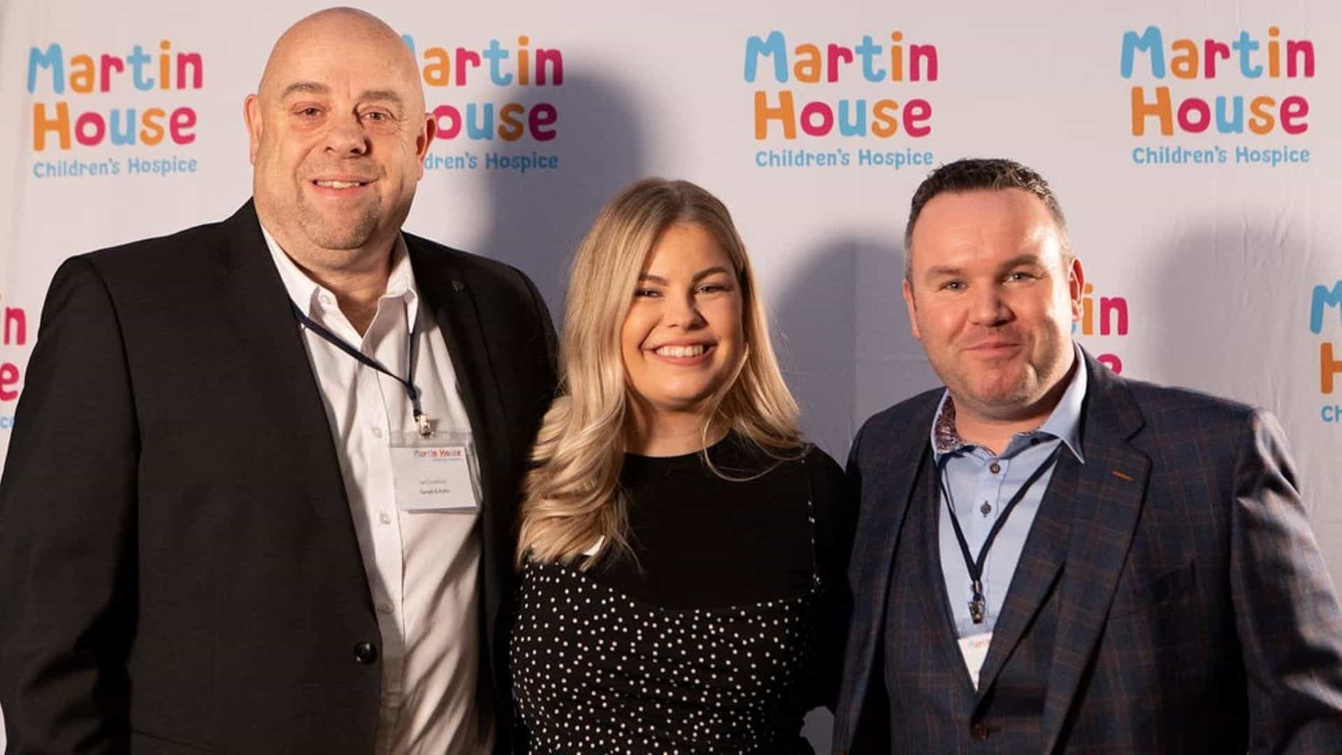 Photo of Abi and partners Gough & Kelly in front of Martin House back drop