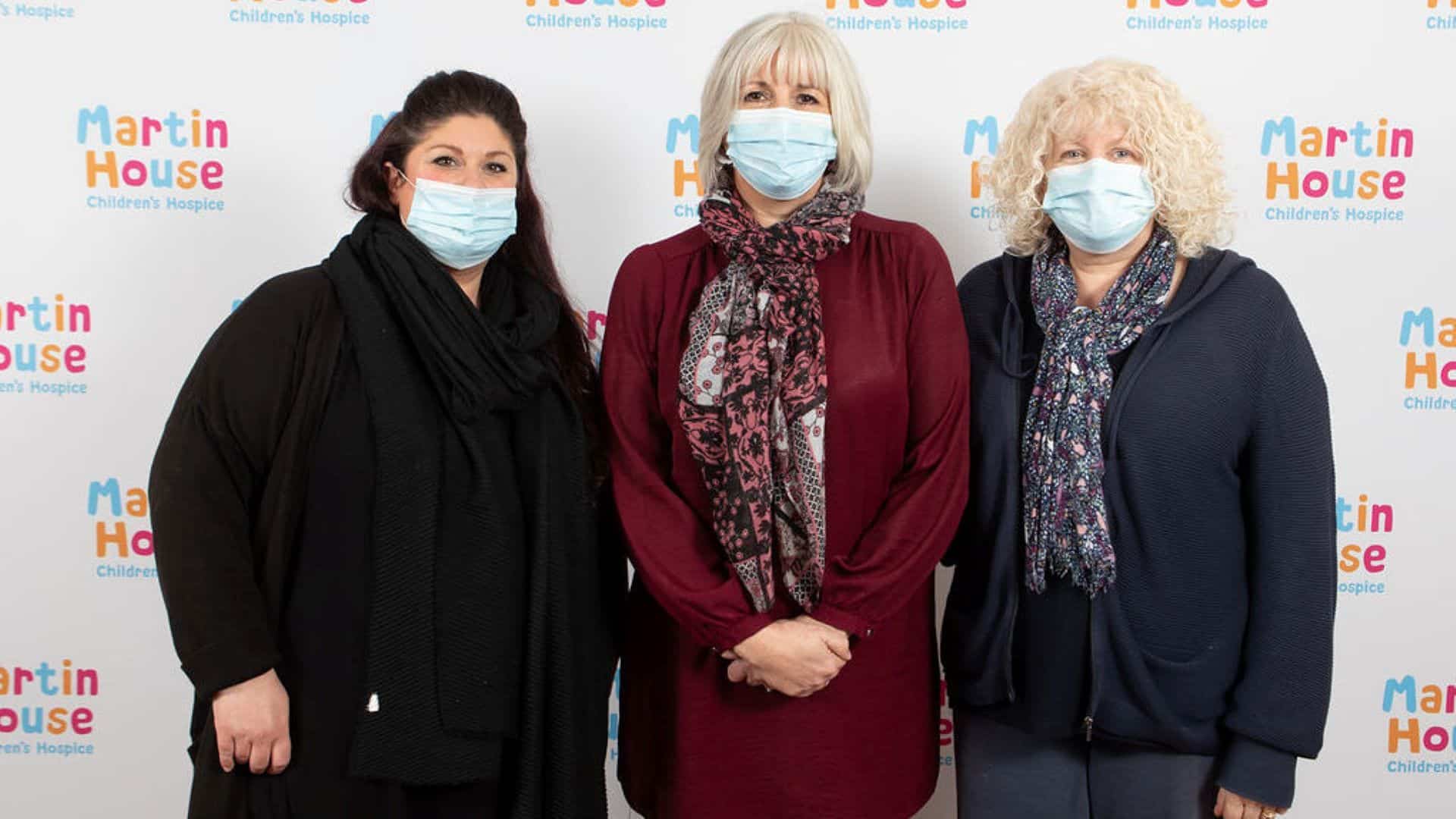Bereavement team Three women stood in front of Martin House back drop