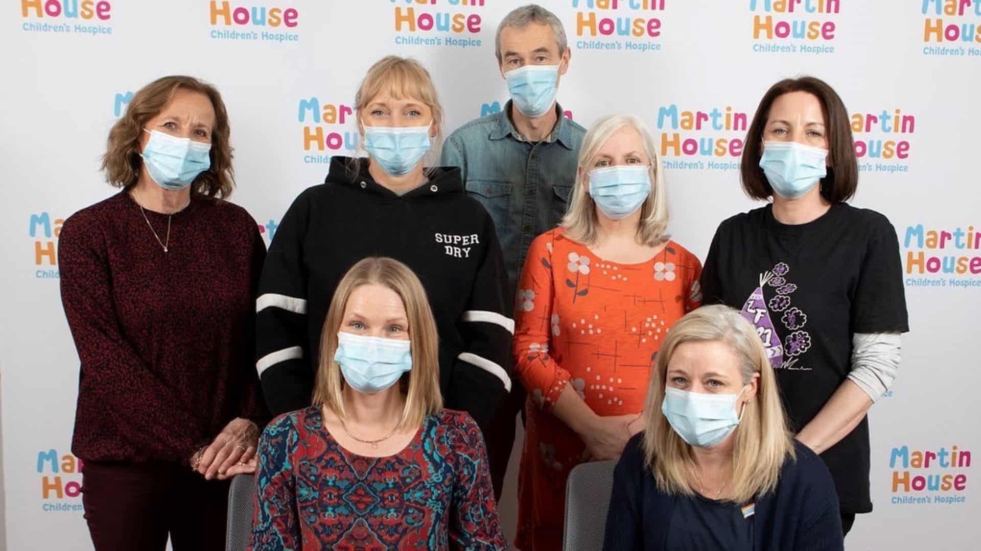 Seven women stood in front of Martin House backdrop.