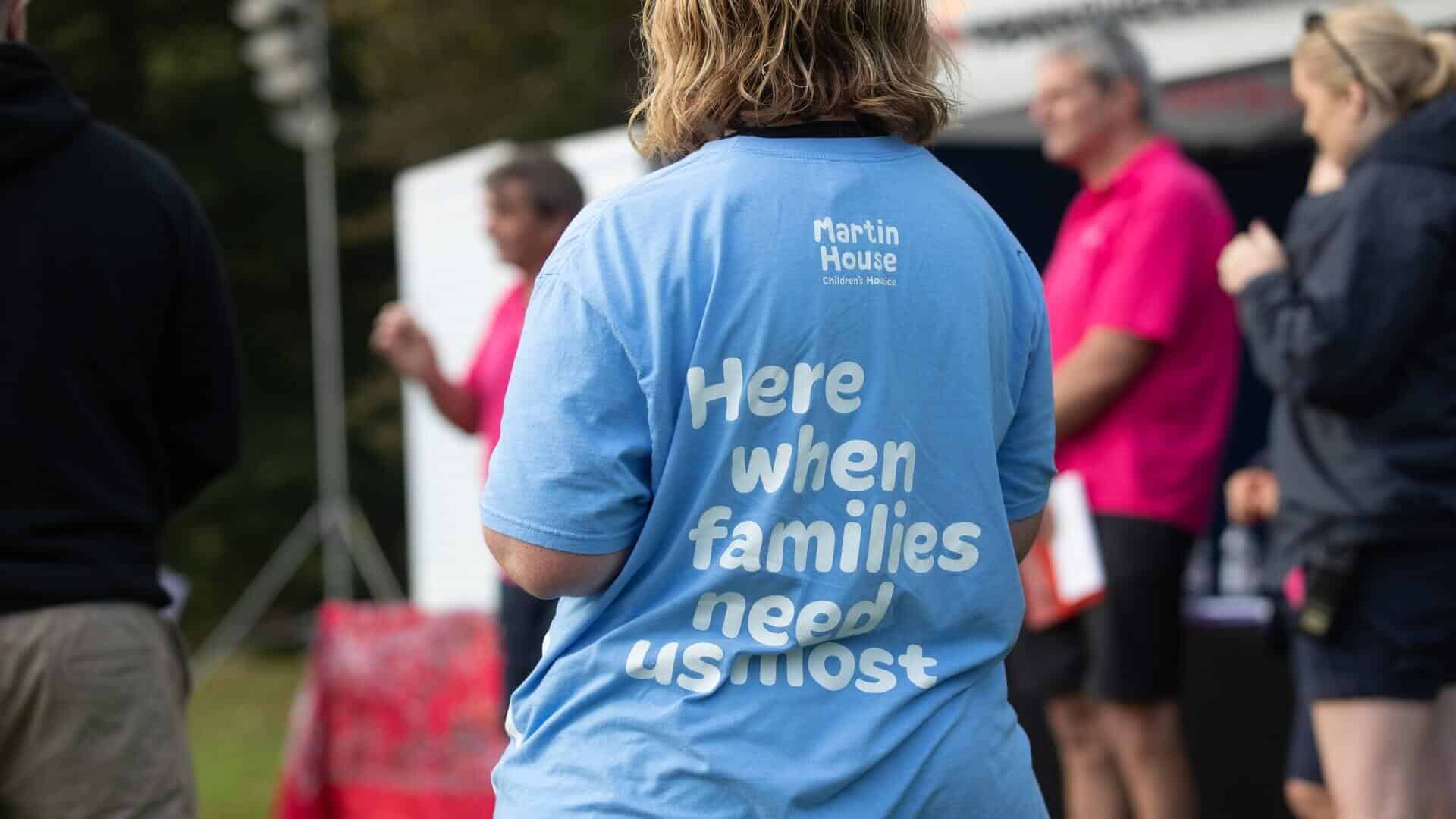 Back of tshirt saying 'here when families need us most.'