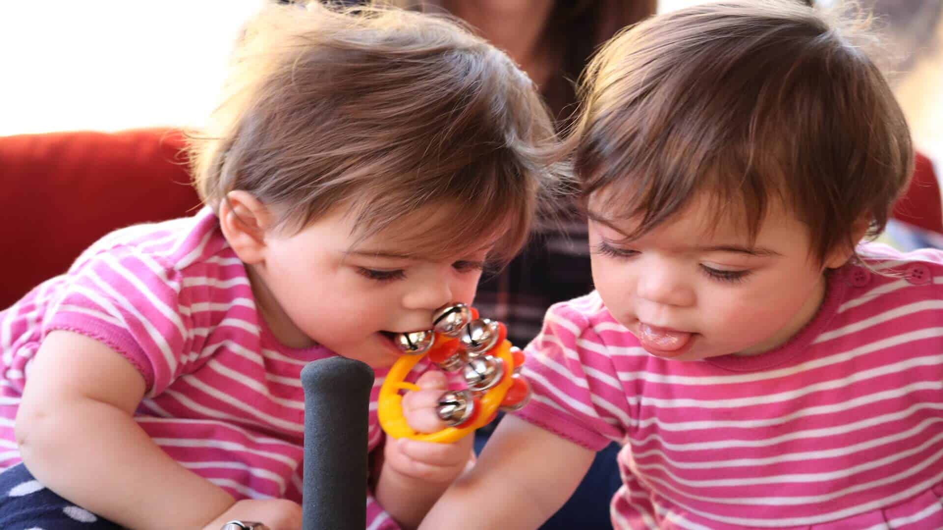 Two young twin girls playing