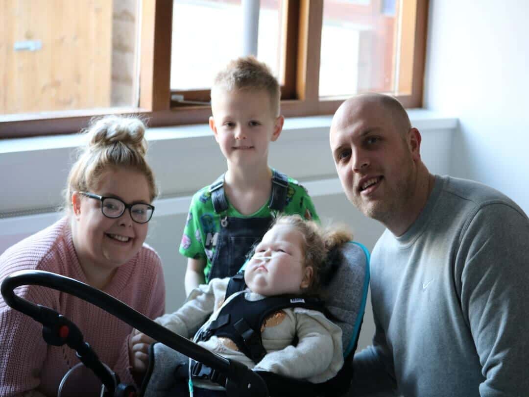 Family with young boy, young girl, woman and man.