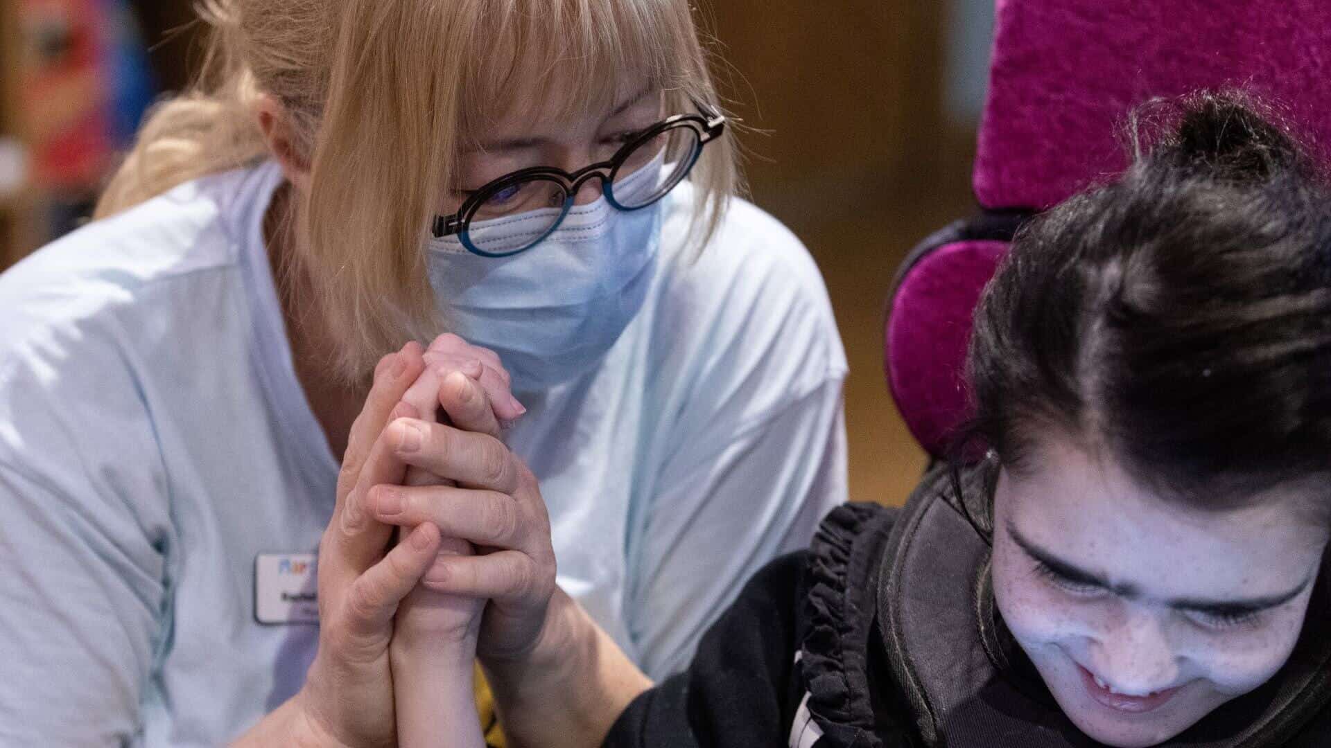 Woman helping young girl