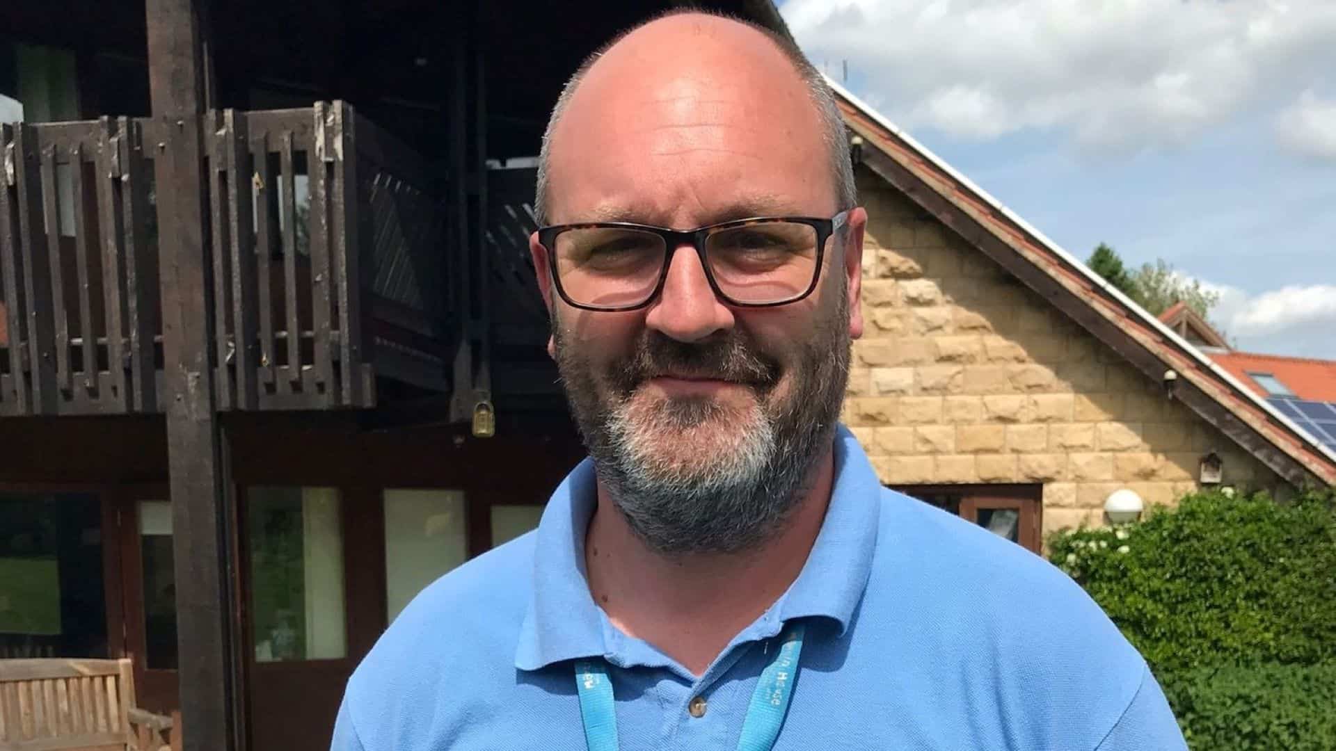 Chris Backhouse stood outside Martin House wearing Martin House t-shirt