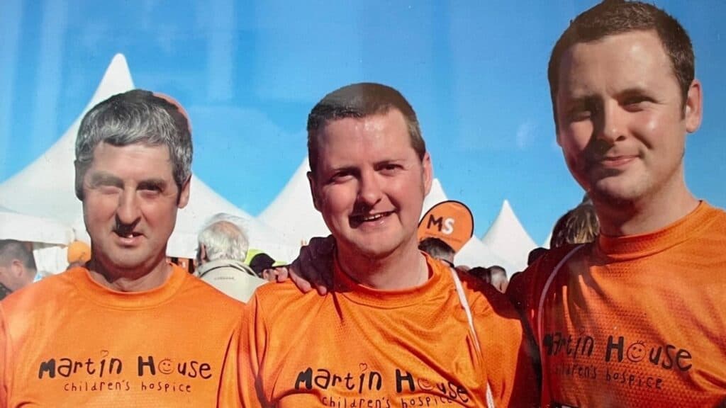 Photo of three men at Great North Run wearing Martin House t-shirts.