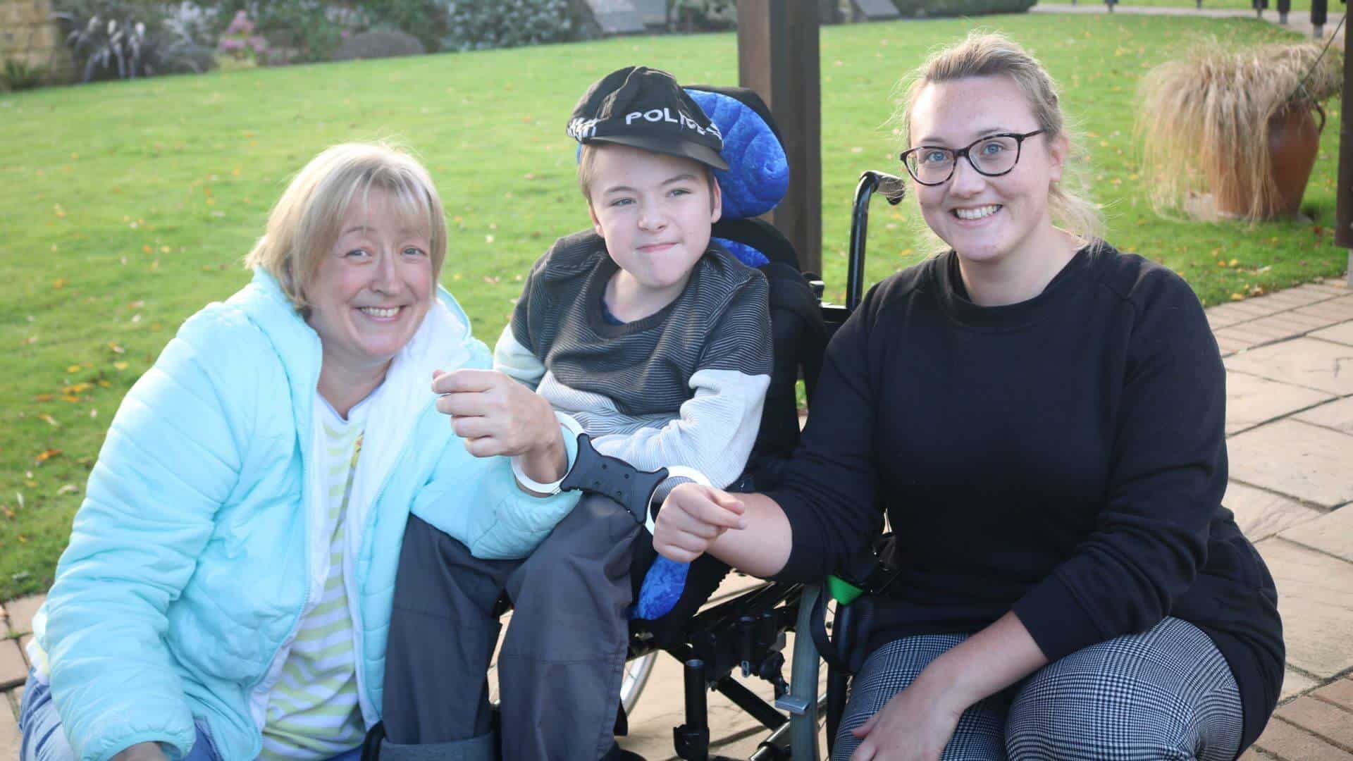 Two women smiling with young boy