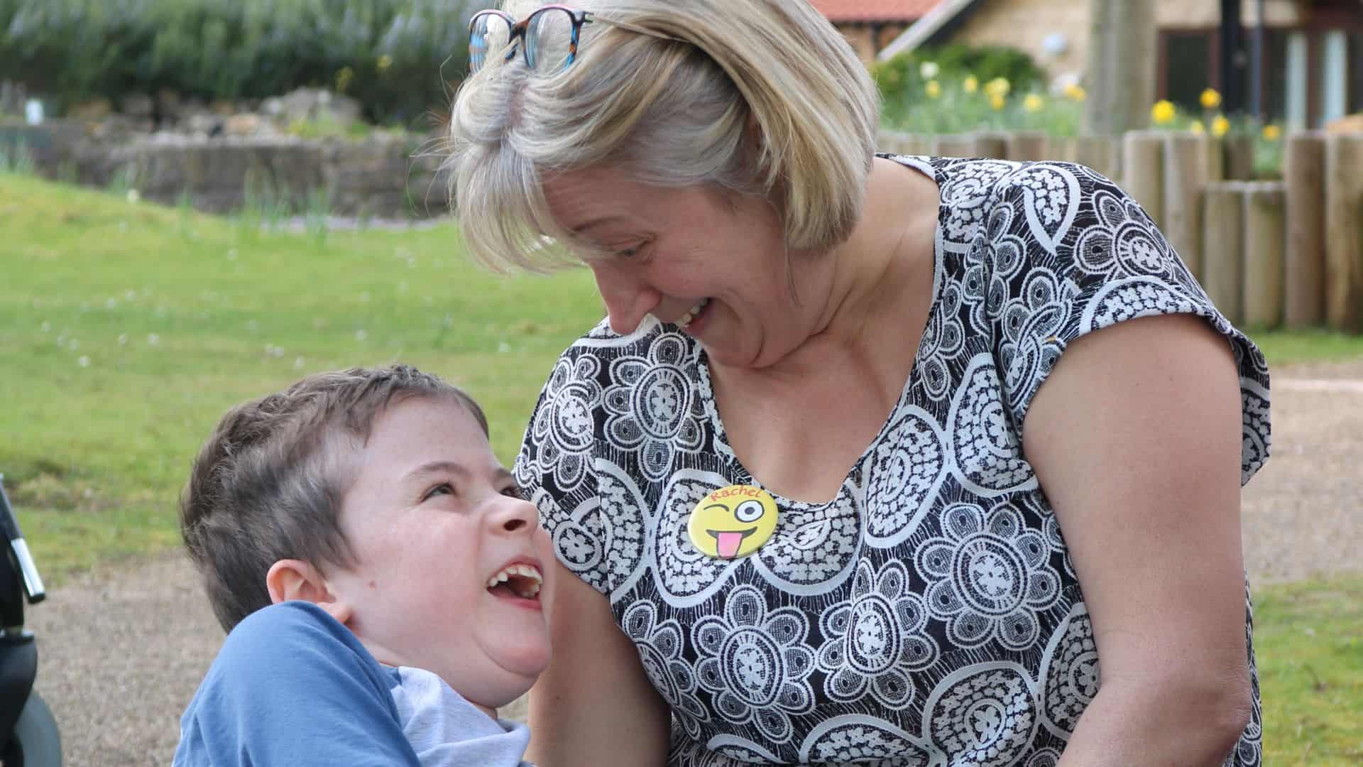 Woman and young boy smiling with eachother