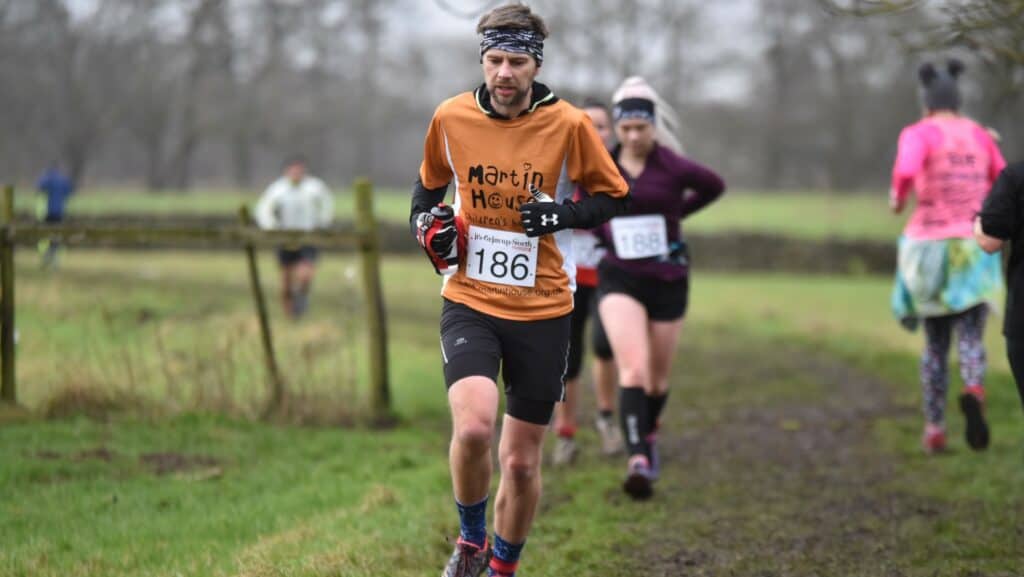 Peter running wearing Martin House t-shirts.