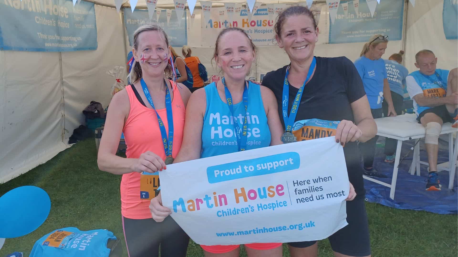 Three women smiling at Great North Run,