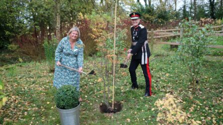 Chief Executive Claire Holdsworth and Mr Anderson planting Queen's tree in hospice gardens