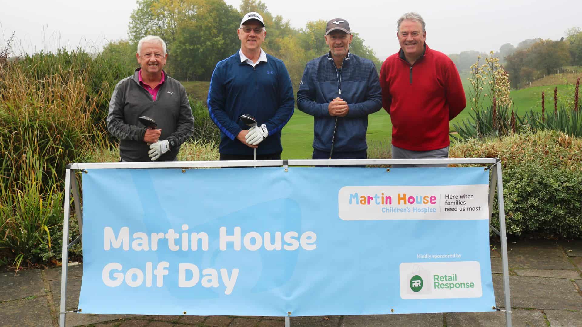 Four men smiling at Martin House Golf Day event.