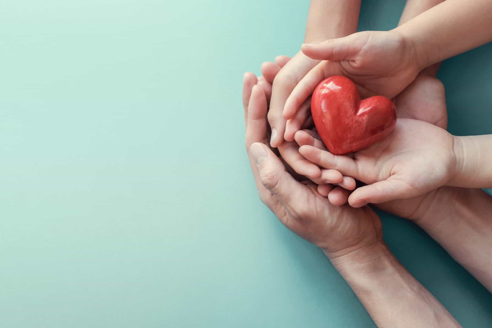 Shutterstock 1487364161 Min Hands holding a heart.