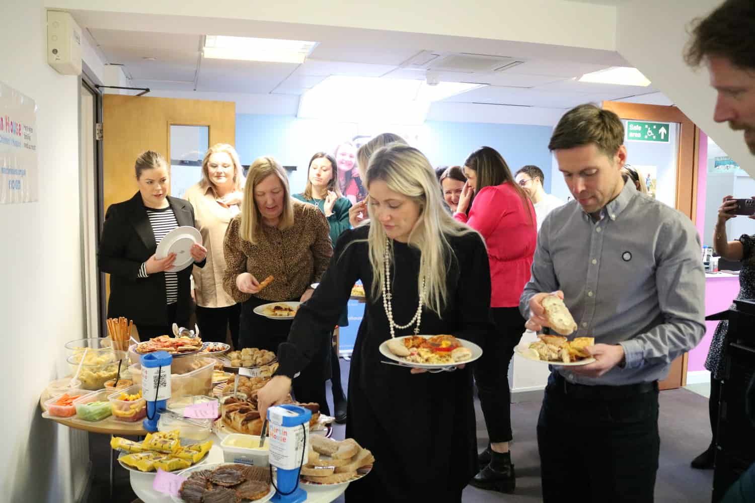 People serving themselves food at a buffet
