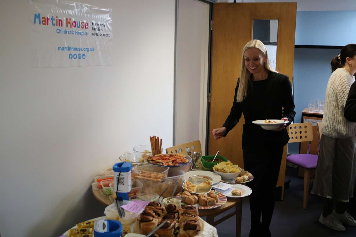 Woman getting food from a buffet