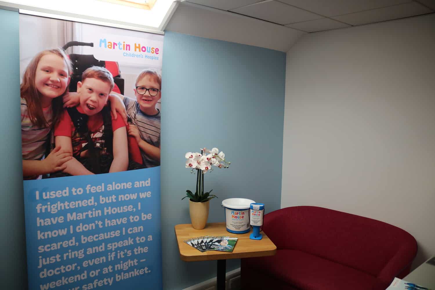 Martin House collection tin, flyers and banner in office.