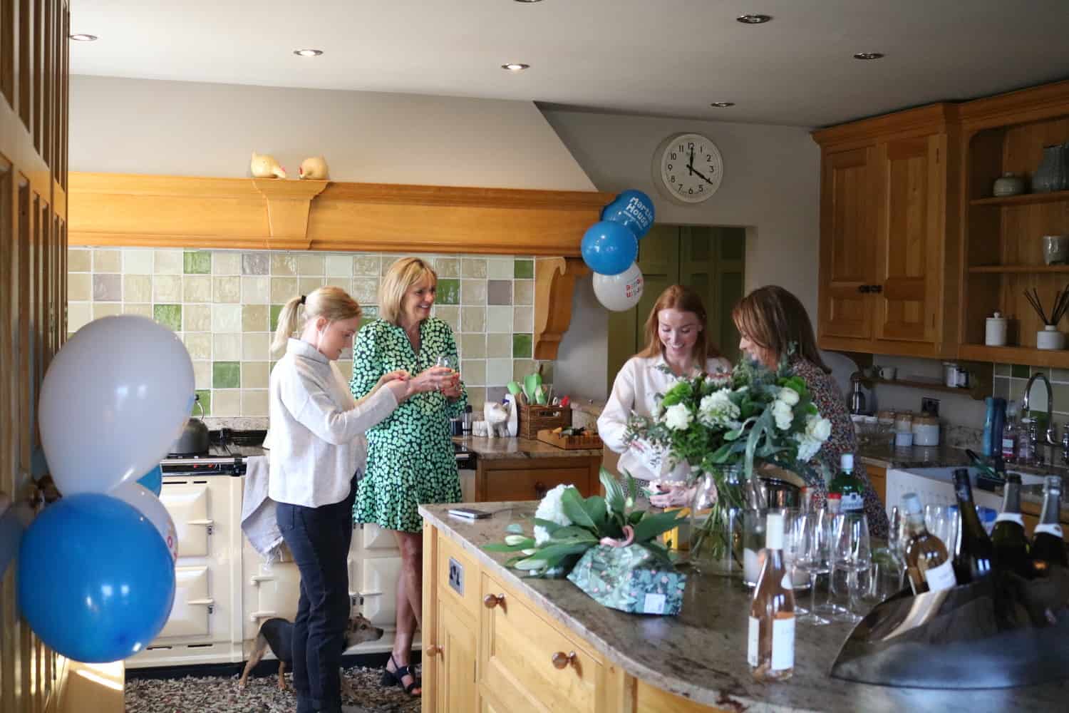 Ladies chatting in a kitchen in home.
