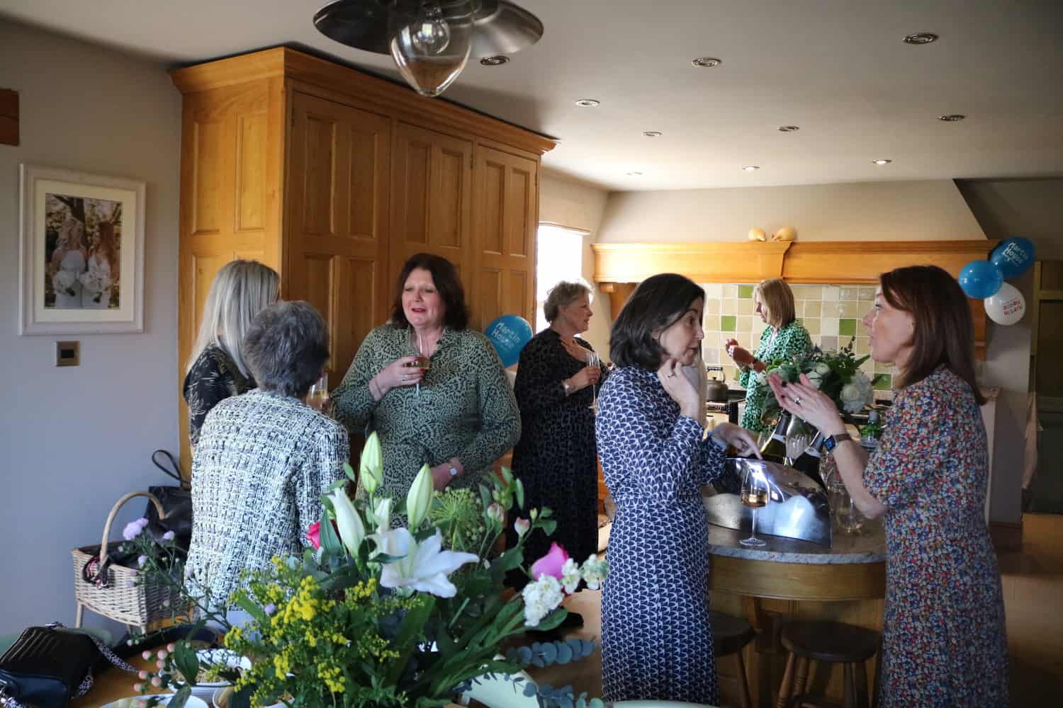 Ladies chatting in a kitchen in home.
