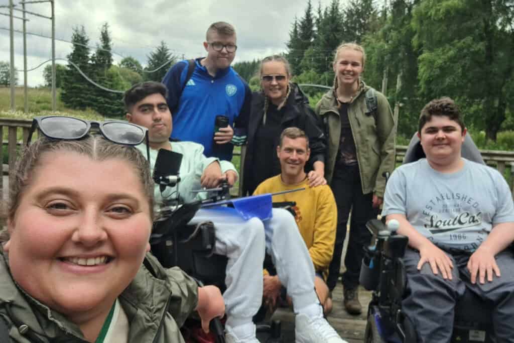 An image showing young people from Martin House and Care Team Members smiling at our annual Calvert Kielder adventure trip.